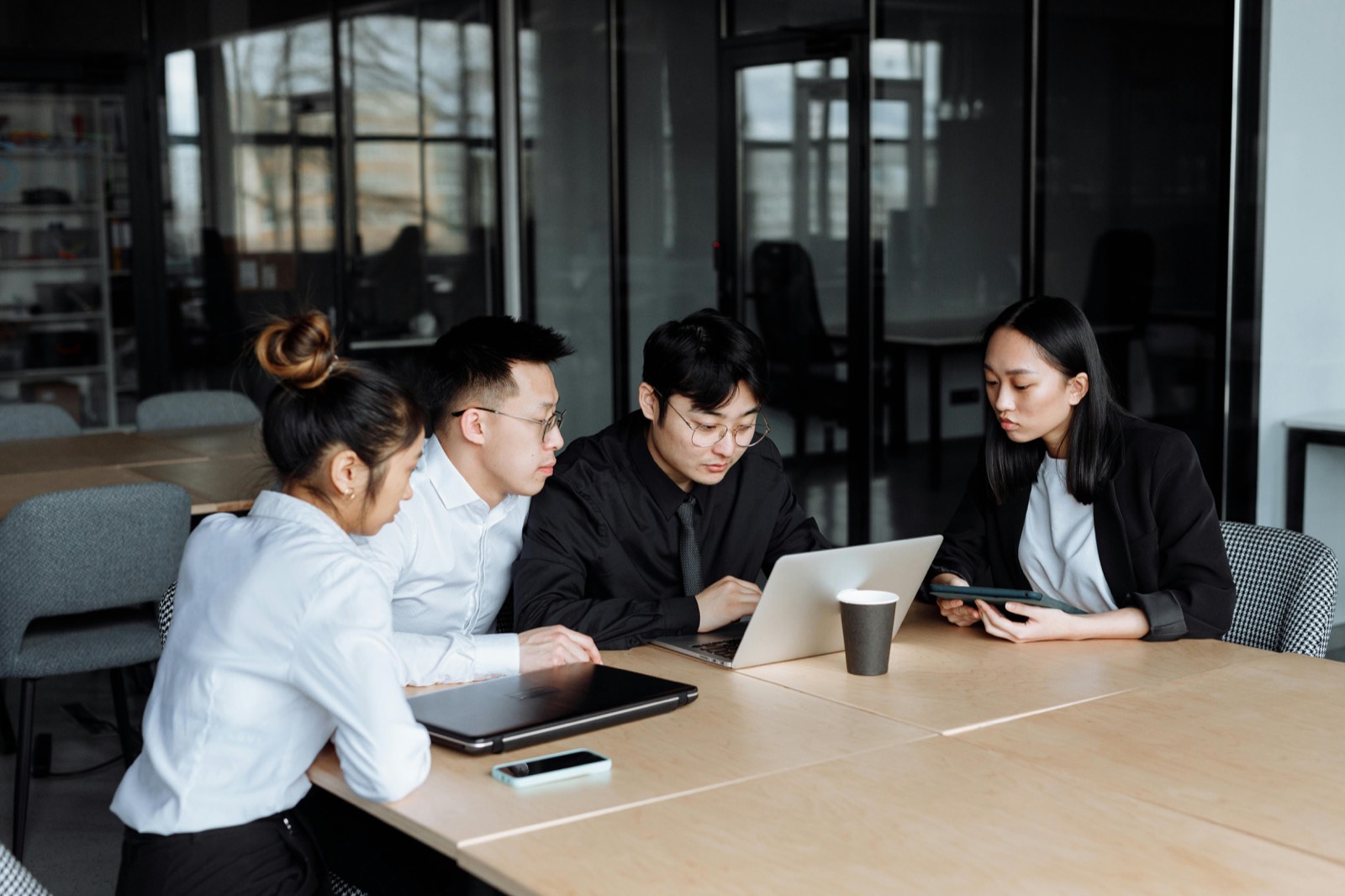 Business team reviewing workflow plans on a laptop